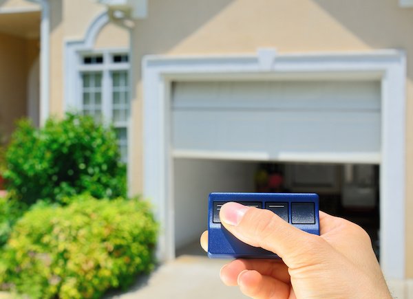 An electronic garage door opener being tested by a homeowner